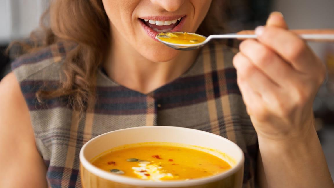 woman eating soup